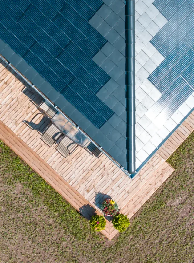 Aerial view of a Solar Tiled Roof™ with integrated solar panels above a wooden terrace