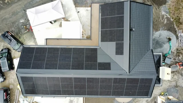 Top-down aerial view of an integrated solar roof during building construction.
