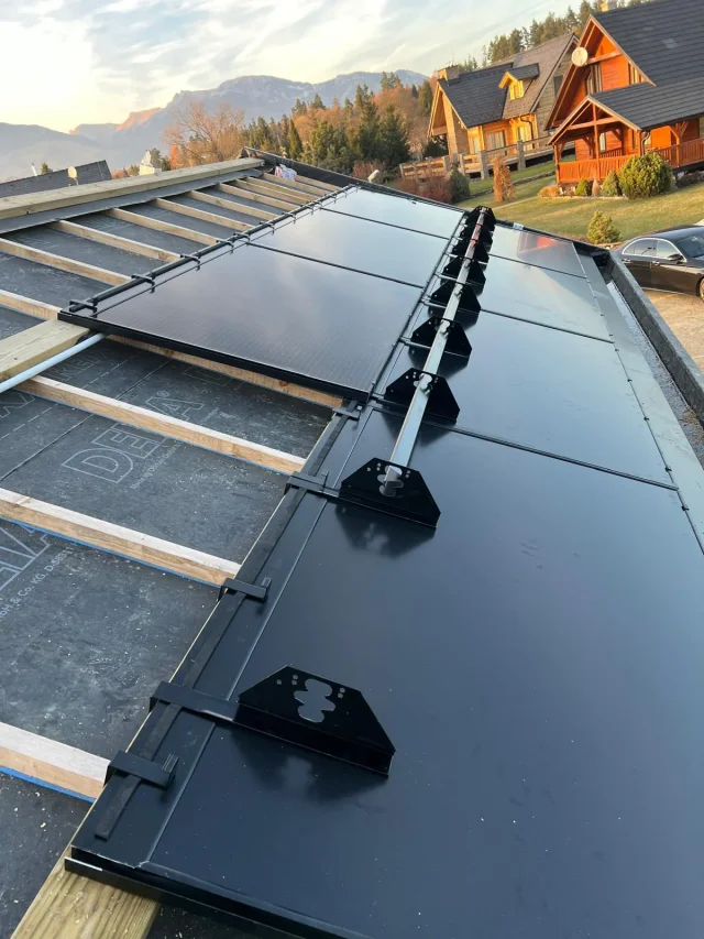 Close-up of Solar Full Roof™ modules with a roof safety rail installed across the panel surface.