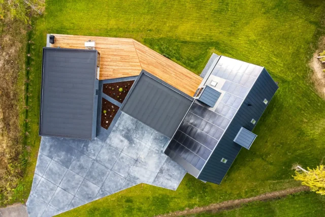 Aerial view of a modern home with an integrated solar roof.