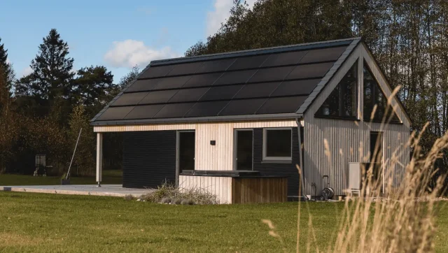 Modern timber house with an integrated solar roof.