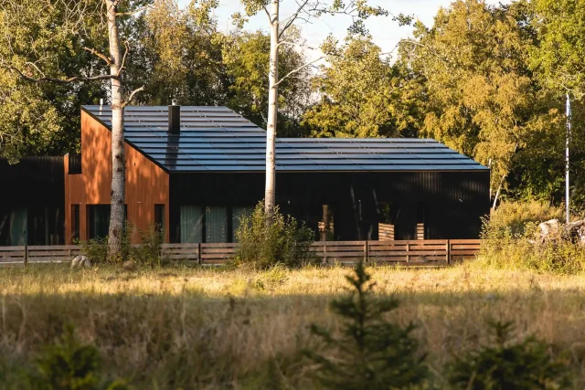 Modern woodland home with an integrated solar roof.