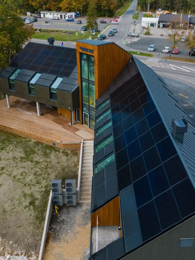 Aerial view of a modern building with integrated solar roofs in Muhu, Estonia.