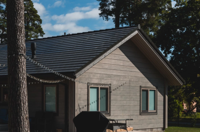 House with integrated solar roof tiles on a pitched roof. Solarstone.