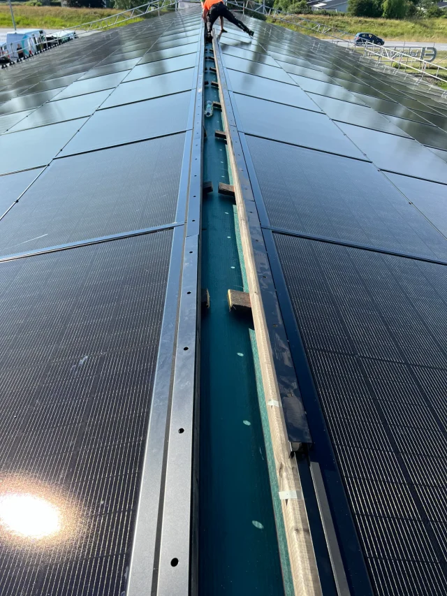 Close-up of the central channel between rows of Solar Full Roof™ modules.