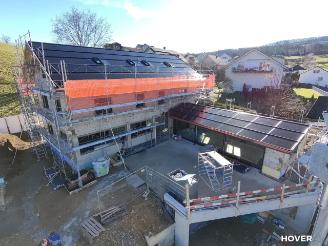 Aerial view of a Solar Full Roof™ construction site with scaffolding in Switzerland.