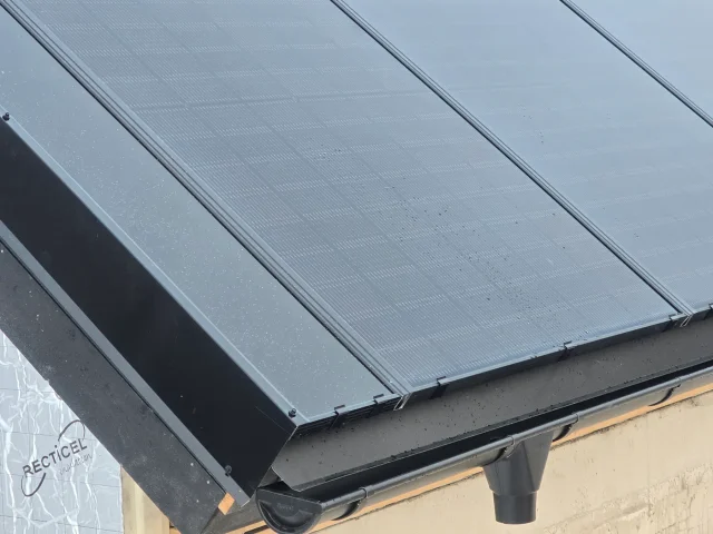 Close-up of completed Solar Full Roof™ modules meeting the eave and rain gutter.