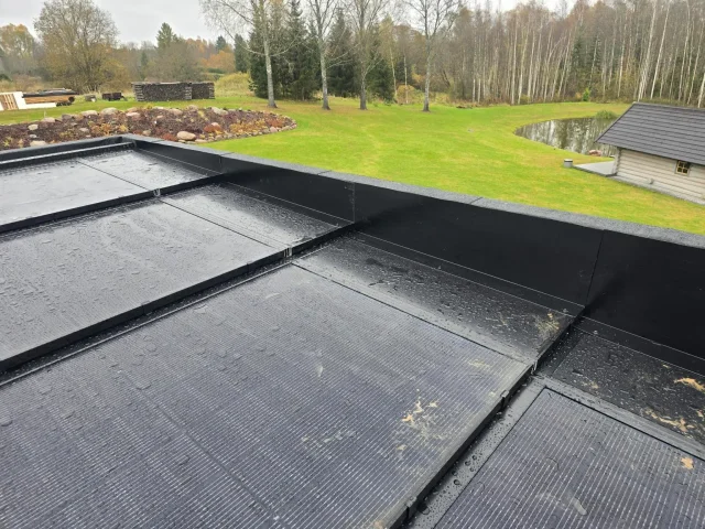 Solar Full Roof™ modules arranged across a low-pitched roof during installation.