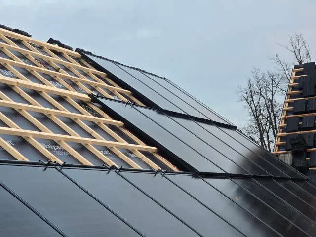 Wide view of Solar Full Roof™ modules installed beside exposed timber roof battens.