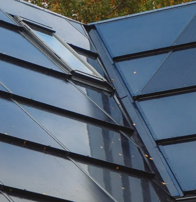 Close-up of Solar Full Roof™ modules fitted around two roof windows.