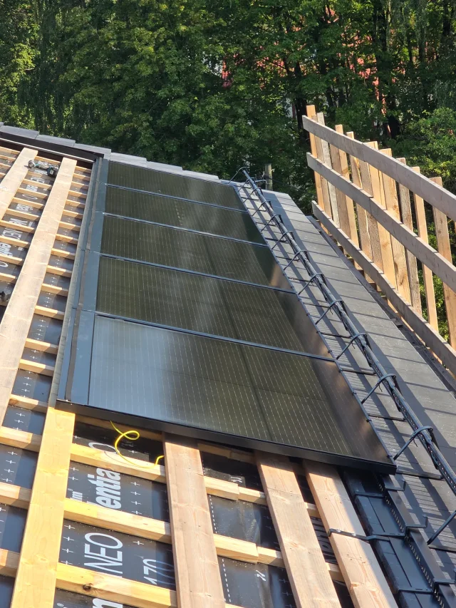 Vertical view of a partial Solar Full Roof™ installation beside exposed roof battens.