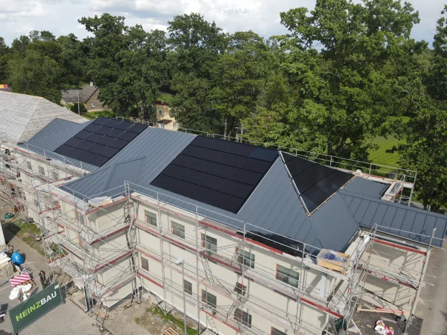 Aerial view of a Solar Full Roof™ installation across several sections of a scaffolded building.