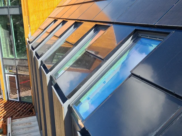 Solar Full Roof™ modules and metal flashing fitted around a roof window.