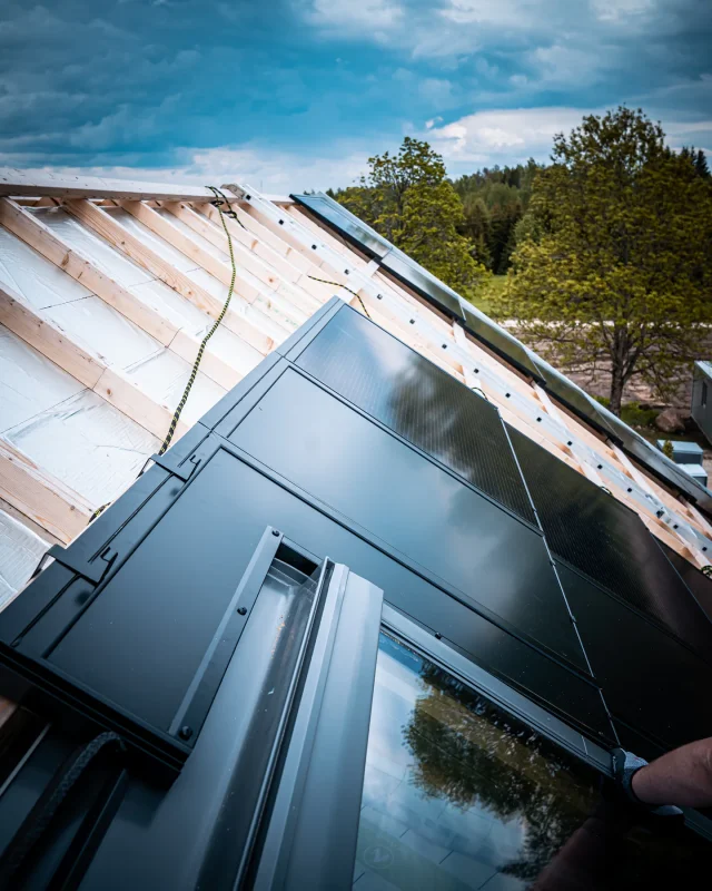 Solar Full Roof™ modules integrated around roof windows and a metal valley.