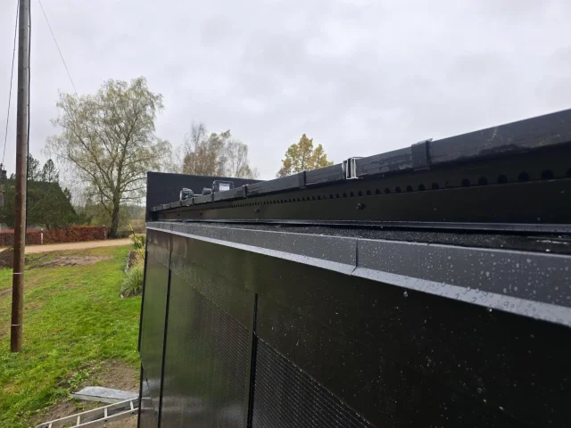 Close-up of a ventilated eave profile beneath Solar Full Roof™ modules.
