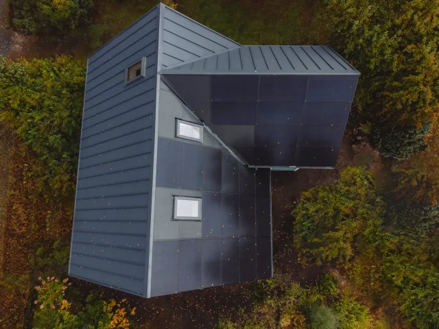 Aerial view of integrated solar roofing combined with standing-seam metal roofing.