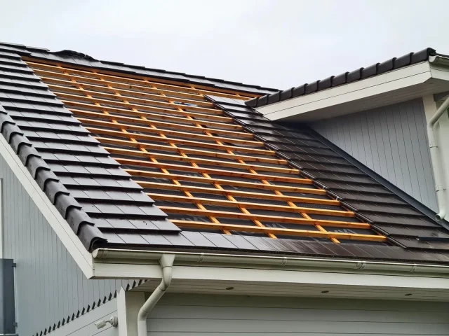 Roof section cleared of brown tiles and prepared for a Solar Tiled Roof™ retrofit.