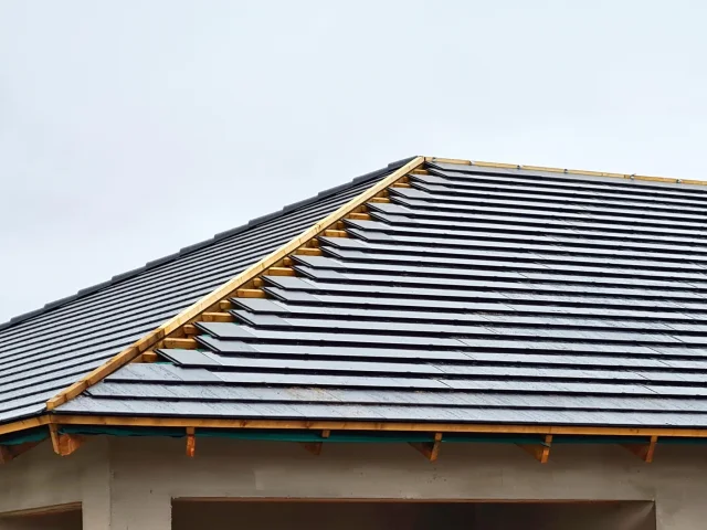 Tiled roof with an unfinished timber hip and ridge during a Solar Tiled Roof™ installation.