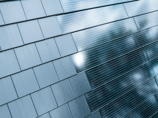 Close-up of Solar Tiled Roof™ photovoltaic panels integrated with dark roof tiles.