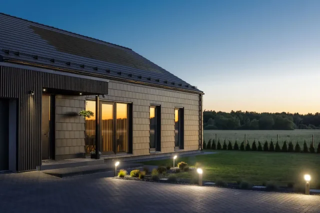 Modern home with a Solar Tiled Roof™ installation at dusk.