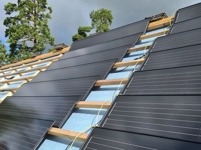 Solar Tiled Roof™ modules installed on timber battens with electrical cables still exposed.