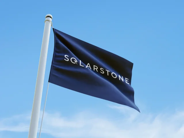 Blue Solarstone flag flying against a clear sky.