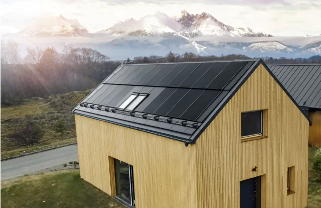 Wooden home with an integrated solar roof and mountain views in Slovakia.