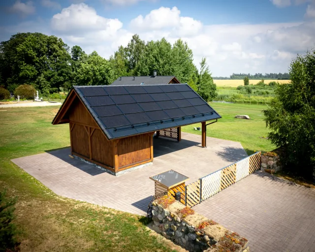 Aerial view of a wooden pavilion with a full integrated solar roof.